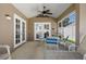 Covered patio includes ceiling fan and doors to the backyard offering comfortable outdoor living at 144 Bridgeton St, Davenport, FL 33896