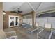 Covered patio has outdoor furniture and opens up to a spacious, well-maintained backyard at 144 Bridgeton St, Davenport, FL 33896