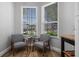 Bright sitting area with windows and seating offers a tranquil space to enjoy natural light at 144 Bridgeton St, Davenport, FL 33896