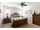 Cozy bedroom with a wooden bed, tropical bedding, and ample closet space at 14845 Speer Lake Dr, Winter Garden, FL 34787