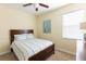 Bright bedroom features a ceiling fan, window and pleasing wall decor at 14845 Speer Lake Dr, Winter Garden, FL 34787
