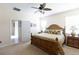 Bright bedroom with tropical bedding, side tables, and carpet flooring at 14845 Speer Lake Dr, Winter Garden, FL 34787