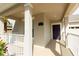 Covered front porch featuring a purple door, brick floor and beige walls at 14845 Speer Lake Dr, Winter Garden, FL 34787