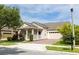 Charming single Gathering home featuring a well-manicured lawn and a brick driveway leading to an attached two-car garage at 14845 Speer Lake Dr, Winter Garden, FL 34787