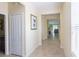 Inviting hallway with neutral paint, tile flooring, and views into the living area at 14845 Speer Lake Dr, Winter Garden, FL 34787