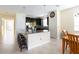 Open-concept kitchen with breakfast bar, granite counters, stainless steel appliances, and adjacent dining area at 14845 Speer Lake Dr, Winter Garden, FL 34787