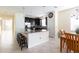 Open-concept kitchen with breakfast bar, granite counters, stainless steel appliances, and adjacent dining area at 14845 Speer Lake Dr, Winter Garden, FL 34787