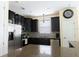 Modern kitchen featuring dark cabinetry, granite countertops, stainless steel appliances, and tile backsplash at 14845 Speer Lake Dr, Winter Garden, FL 34787