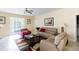 Comfortable living room with tan couches, a ceiling fan, and a colorful area rug at 14845 Speer Lake Dr, Winter Garden, FL 34787