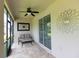 Relaxing screened patio with tile flooring, ceiling fan and outdoor decor at 14845 Speer Lake Dr, Winter Garden, FL 34787