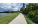 Scenic walking path next to a lake, offering a serene escape into nature and beautiful views at 14845 Speer Lake Dr, Winter Garden, FL 34787