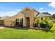 Well-maintained home featuring a manicured lawn and meticulously landscaped garden beds in front of the house at 1507 Alligator St, St Cloud, FL 34771