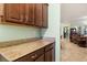 Features granite countertops, dark wood cabinets, with an open view of the living space at 1507 Alligator St, St Cloud, FL 34771