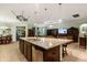 Spacious kitchen island with a stainless dishwasher, sink, and breakfast bar seating area at 1507 Alligator St, St Cloud, FL 34771