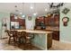 Spacious kitchen featuring wooden cabinets, granite countertops, stainless steel appliances, and barstool seating at 1507 Alligator St, St Cloud, FL 34771