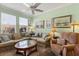 Comfortable living room with a large window, neutral tones, ceiling fan and tastefully framed artwork at 1507 Alligator St, St Cloud, FL 34771
