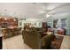Spacious living area with tile floors, ceiling fan, and open concept layout with a kitchen island and bar stools at 1507 Alligator St, St Cloud, FL 34771