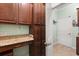 Butler pantry with ample storage space, granite countertops, and an entrance to the home at 1507 Alligator St, St Cloud, FL 34771