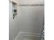 Clean bathroom features white tiled walls, a shower/tub combo, and built-in shelving at 162 Orange Pl, Maitland, FL 32751
