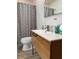 Modern bathroom featuring a stylish vanity with a white countertop and a shower with patterned curtain at 162 Orange Pl, Maitland, FL 32751