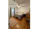 Comfortable bedroom with hardwood floors, a ceiling fan, natural light, and a neutral color scheme at 162 Orange Pl, Maitland, FL 32751