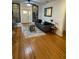 Bright living room with hardwood floors, a gray sofa, and decorative accents near the entry door at 162 Orange Pl, Maitland, FL 32751