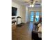Cozy living area with wood-look tile flooring, a ceiling fan, french doors, and access to the backyard at 162 Orange Pl, Maitland, FL 32751