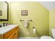 Powder room featuring a vanity sink, bright paint, and a toilet at 16610 County Line Rd, Umatilla, FL 32784