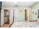 Bedroom featuring a floral bed set with access to the ensuite bathroom and access to the hallway at 16610 County Line Rd, Umatilla, FL 32784