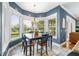Bright breakfast nook with bay window and large wood table, perfect for enjoying views and Gathering time at 16610 County Line Rd, Umatilla, FL 32784