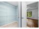 Walk-in closet with wire shelving and a view into the Primary bedroom with a window view at 16610 County Line Rd, Umatilla, FL 32784