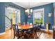 Dining room with large windows, traditional decor, hardwood floors and chandelier at 16610 County Line Rd, Umatilla, FL 32784