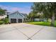 The exterior features a long driveway and additional building in the back of the property at 16610 County Line Rd, Umatilla, FL 32784