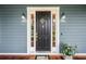 A closer front door shot with sidelights, wood porch and railings, and homey details at 16610 County Line Rd, Umatilla, FL 32784