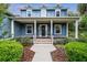 Inviting front porch with decorative columns and wood flooring leads to front door at 16610 County Line Rd, Umatilla, FL 32784