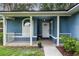 Inviting front porch with white railings, flower pots, and a well-maintained entrance at 16610 County Line Rd, Umatilla, FL 32784