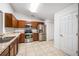 Well-lit kitchen featuring stainless steel appliances, wooden cabinets and light colored countertops at 16610 County Line Rd, Umatilla, FL 32784