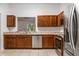 Bright kitchen featuring granite countertops, wooden cabinets and stainless steel appliances at 16610 County Line Rd, Umatilla, FL 32784