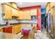 Spacious kitchen features stone tile backsplash, wood cabinets, stainless appliances, and a kitchen island at 16610 County Line Rd, Umatilla, FL 32784