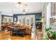 Cozy living room featuring hardwood floors, ceiling fans, fireplace, and sliding doors to the outside at 16610 County Line Rd, Umatilla, FL 32784