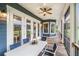 Covered, screened-in porch with a ceiling fan and plenty of space for outdoor furniture at 16610 County Line Rd, Umatilla, FL 32784