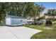 Exterior of the shed and surrounding yard with trees, a boat, and other outdoor equipment at 16610 County Line Rd, Umatilla, FL 32784