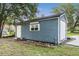 Exterior shot of the storage shed showcasing its siding, door, window, and roll-up door at 16610 County Line Rd, Umatilla, FL 32784