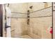 Close-up of tiled walk-in shower with a decorative shower caddy and built in shelf at 16610 County Line Rd, Umatilla, FL 32784