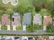 An aerial view reveals homes with manicured lawns, and golf course, situated in a well-maintained community at 16950 Se 80Th Bellavista Cir, The Villages, FL 32162