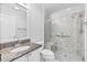 Bathroom featuring granite counters, a sink, and a glass-enclosed shower with a seat at 16950 Se 80Th Bellavista Cir, The Villages, FL 32162