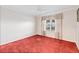 Bedroom featuring plush red carpeting, a window, and modern decor at 16950 Se 80Th Bellavista Cir, The Villages, FL 32162