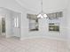 Bright dining area featuring tile floors, decorative lighting, and windows with gingham valances at 16950 Se 80Th Bellavista Cir, The Villages, FL 32162