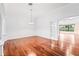 Elegant dining room with gleaming hardwood floors and a decorative chandelier at 16950 Se 80Th Bellavista Cir, The Villages, FL 32162