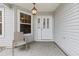 Inviting front porch featuring a chair, decorative light fixture, and front door at 16950 Se 80Th Bellavista Cir, The Villages, FL 32162